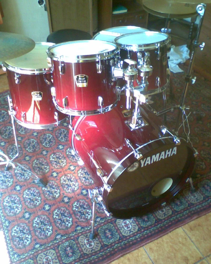 Red Yamaha drum kit on a patterned rug